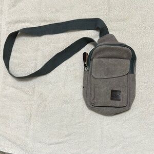 Compact Gray Crossbody Bag with Adjustable Strap and Zippered Compartment